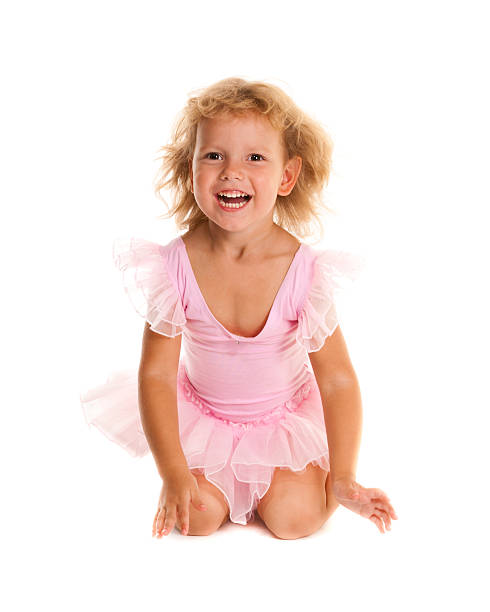 A young girl ballet dancer in a pink lace tutu. Isolated on white background.