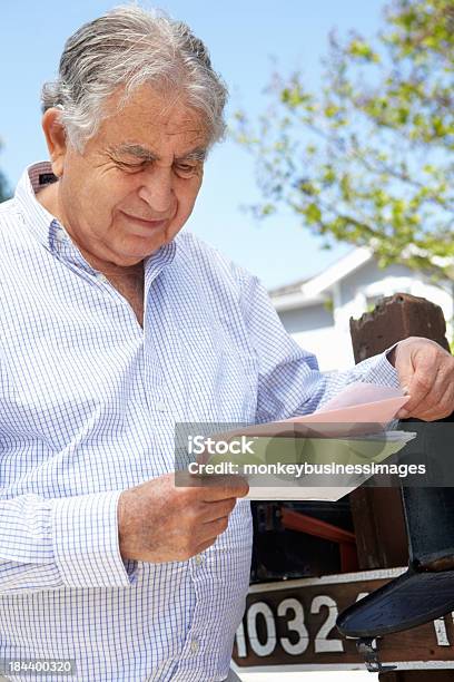 A Man Reading Letters From His Mailbox Stock Photo - Download Image Now - Financial Bill, 80-89 Years, Adult