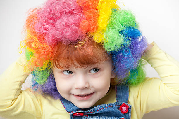 istock Young girl with clown wig 184400605