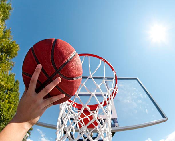 istock Basketball goal and ball with sun in sky 184401707