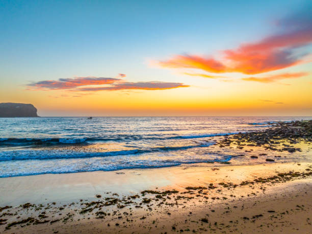 istock Sunrise at the seashore with colour in the clouds 1844018109