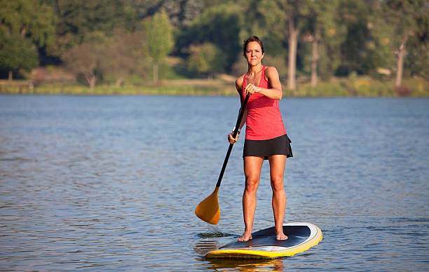istock Athletic Woman Paddle Boarding on a Calm Midwestern Lake. 184402064