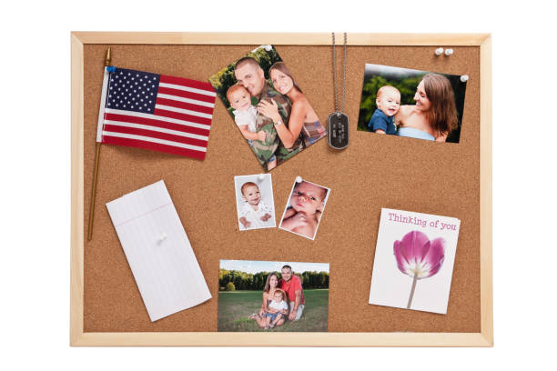 Soldier Mementos "A soldier's cork board containing his dog tags, photos of his wife and child, a flag, love note and greeting card.All photos and greeting card are copyright by Sharon Dominick." bulletin board photos stock pictures, royalty-free photos & images