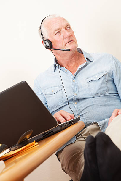 istock Man Working at Home With Headset Looking Away 184402669