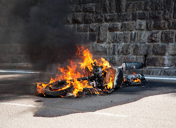 motorcycle burning after accident stock photo