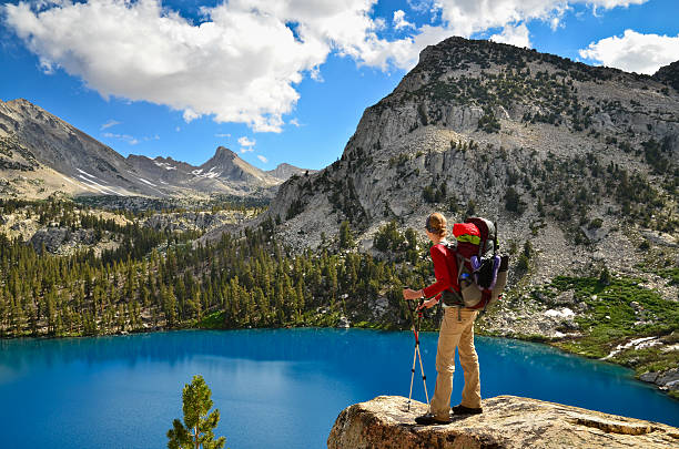 A woman looks out over the aqua-blue colored Marion Lake in Kings Canyon National Park, California. 