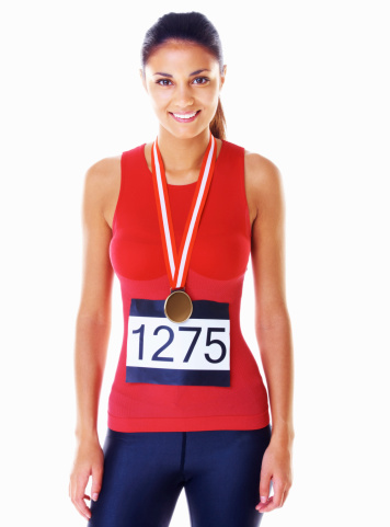 Portrait of marathon female winner smiling on white background