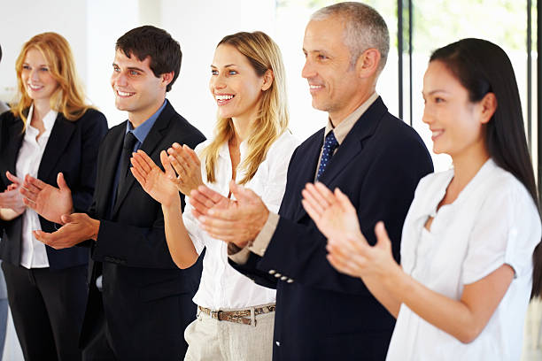 istock Happy executives applauding together 184403727