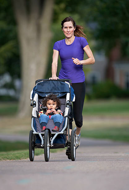 istock Woman running while pushing baby in stroller 184403788