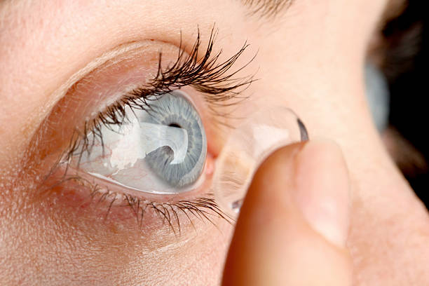 Contact lens Female puts a contact lens in her eye contact lens photos stock pictures, royalty-free photos & images