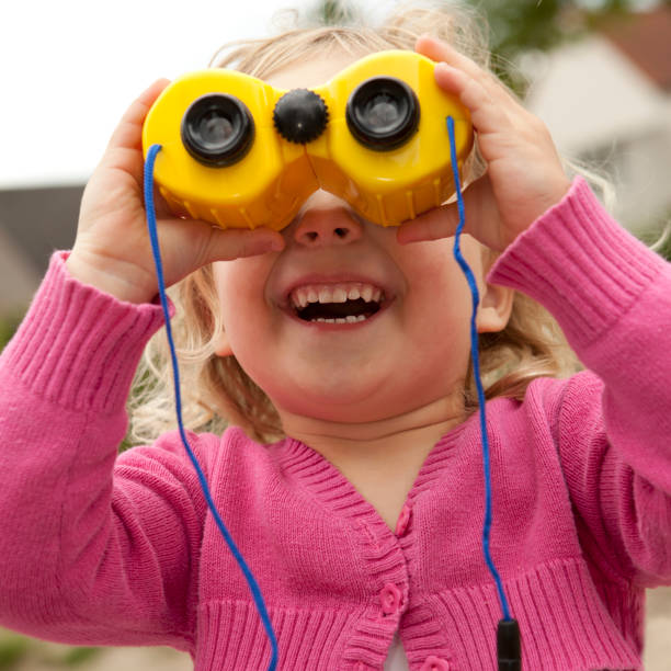 istock Little girl, 3 years old plays with binoculars. 184403994