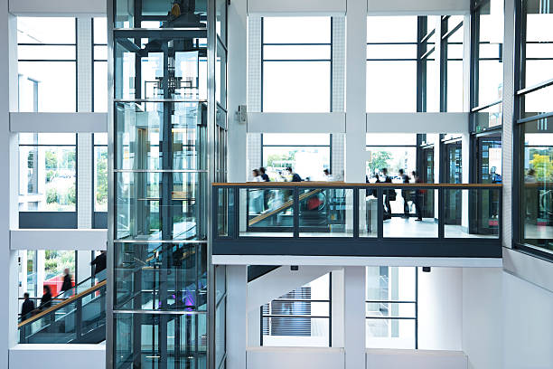 istock Modern Business Hall with Blurred People, Stairs, Escalators and Elevator 184404055