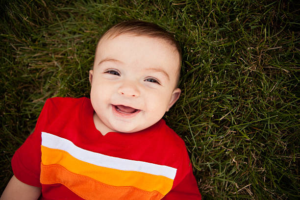 Smiling Baby Boy Lying in Grass