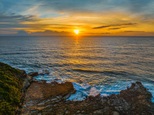 istock Sunrise over the sea and rock platform with high cloud 1844042746