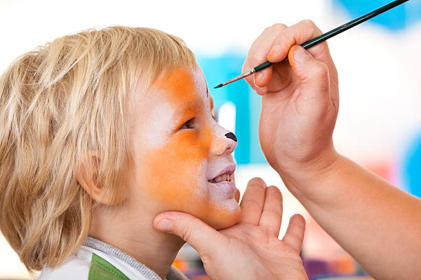 istock Little boy having face painted on birthday party 184404309