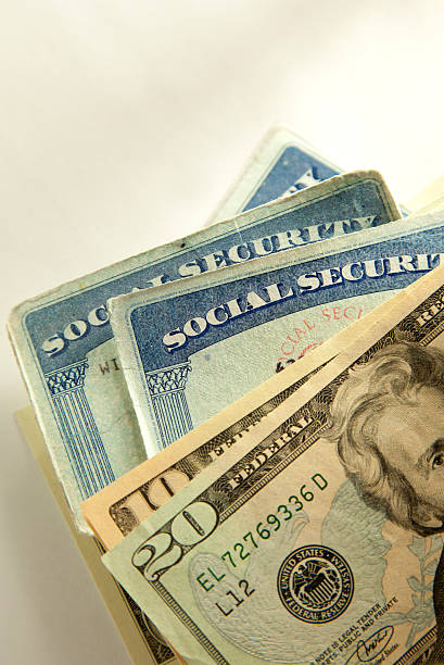 Social Security shot of social security cards and money social security social security card identity us currency stock pictures, royalty-free photos & images