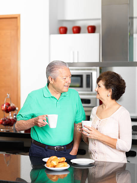 istock Senior couple in the kitchen eating breakfast 184404787