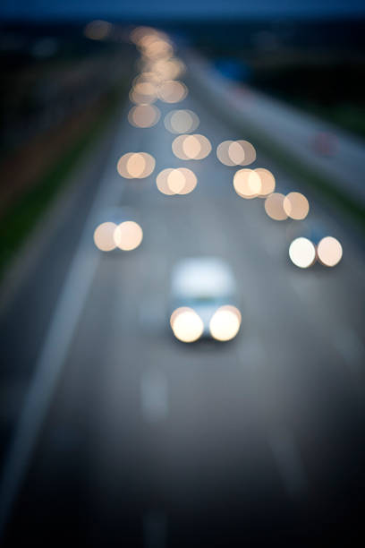 Defocused image of traffic on german autobahn at dusk. Headlights of cars, suitable for a traffic-related background