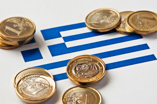 Close-up of a Greek flag and Greek euro coins. Focus is on the Greek euro.Similar images: