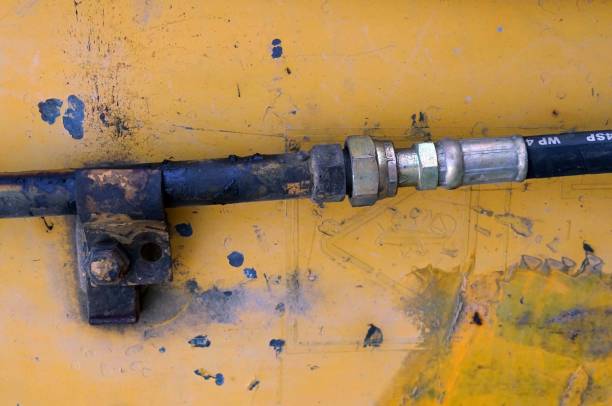 istock Close up  Hydraulic hose cable connected with a hydraulic cylinder installed on an arm of backhoe. 1844074575