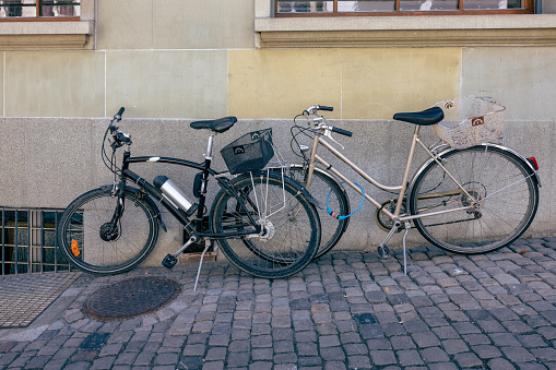 Bicycles on the street parked against the wall