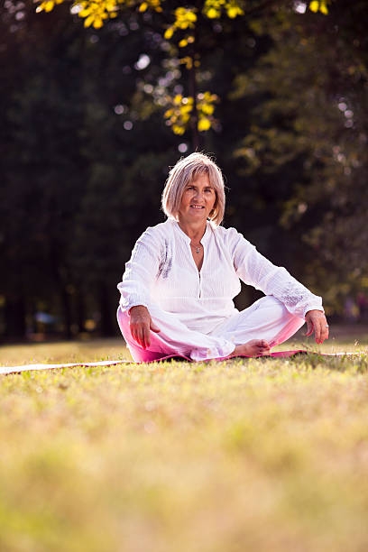 istock senior woman practicing yoga 184409247