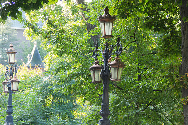 istock Romantic city view, old lamppost, trees and castle 184410590