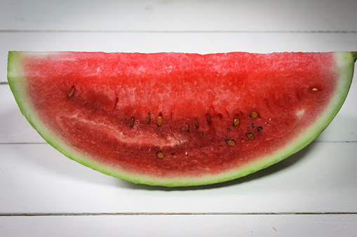 half cut fresh watermelon on a wooden table