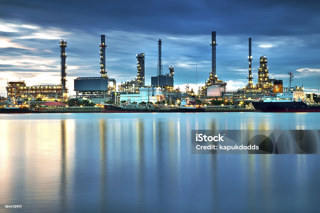 Oil refinery with reflection, petrochemical plant Crude Oil Stock Photo