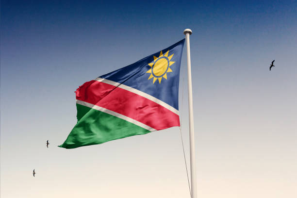 Namibia flag fluttering in the wind on sky. Namibia flag isolated on the sky with clipping path. flag of namibia stock pictures, royalty-free photos & images