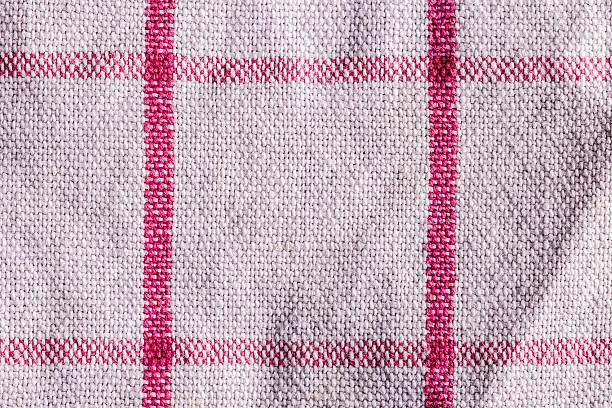 closeup of a white towel with red lines, background texture.