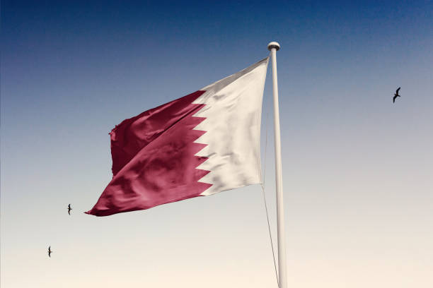 istock Qatar flag fluttering in the wind on sky. 1844153030
