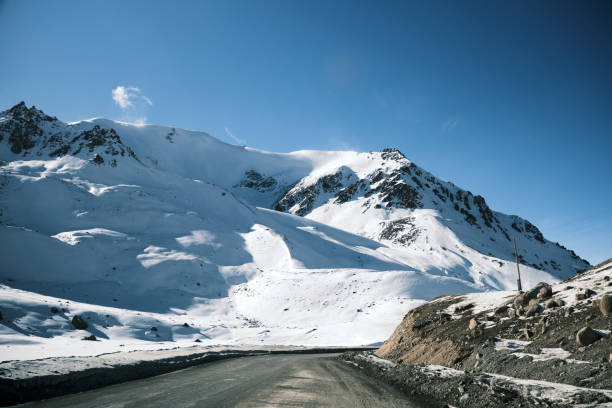 istock Winding road through winter mountain pass 1844158748