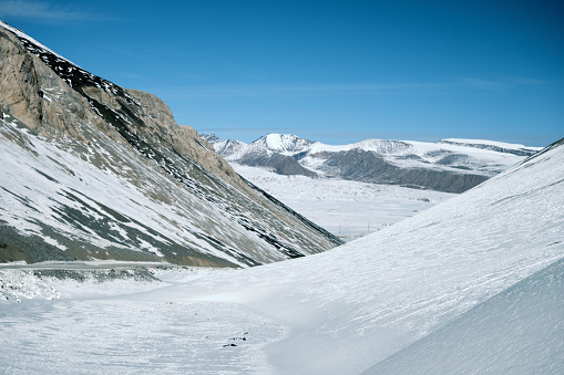 Winding road through winter mountain pass