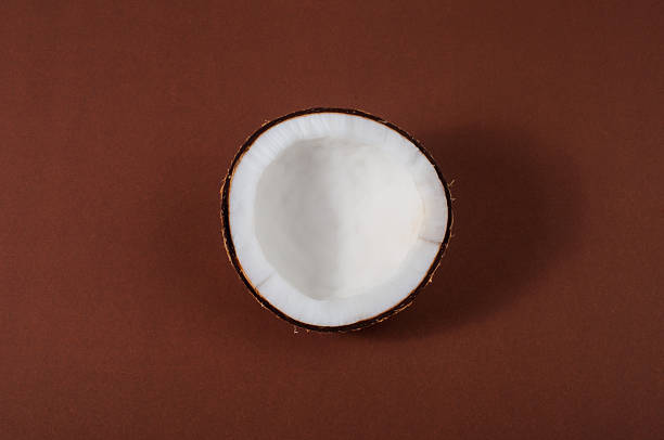 istock Fresh coconut on brown isolated background 184418425