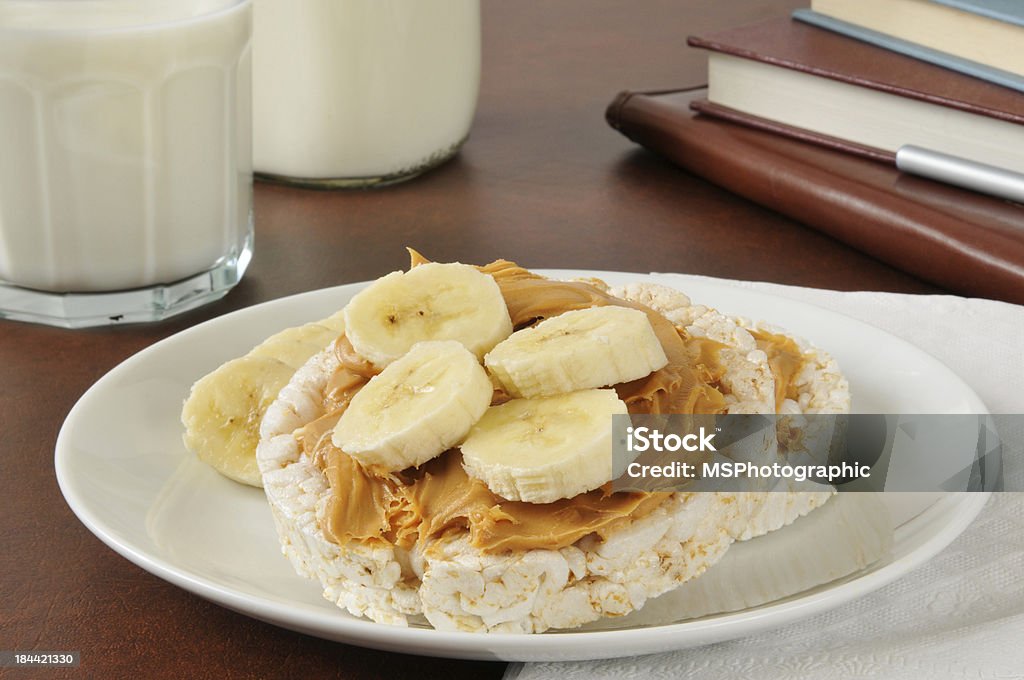 Peanut butter and banana on a rice cake Peanut butter sandwich on a rice cake with milk as an after school snack Peanut Butter Stock Photo