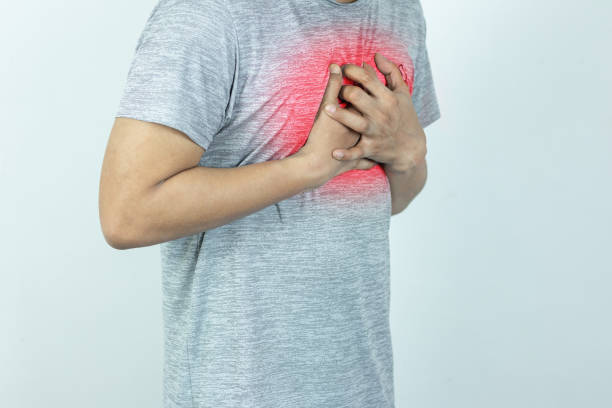 istock asian man pressing chest with painful expression. Severe heartache, having a heart attack or painful cramps, heart disease. 1844226608