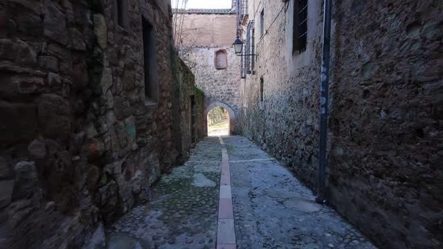 Narrow alley with water fountain in the medieval town of Siguenza, Guadalajara.