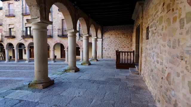 Plaza Mayor of the medieval town of Siguenza with stone arches and columns, Spain