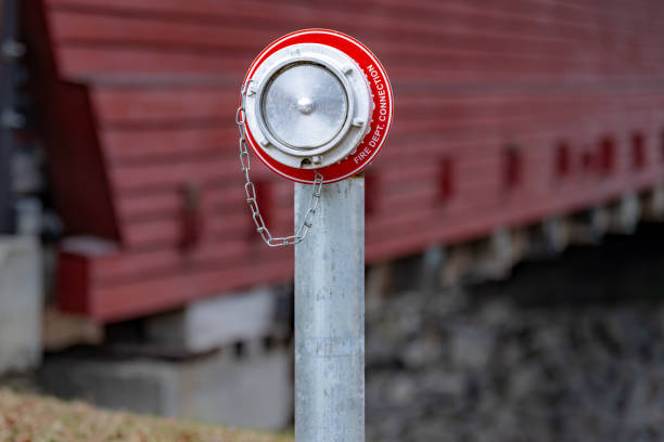 Close up of a fire department dry fire hydrant connection for a sprinkler system for a one lane timber bridge.