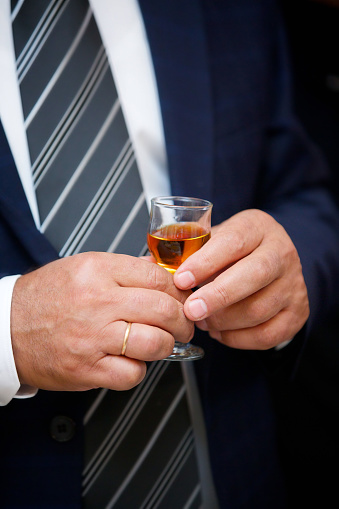 Men's hands with a glass of expensive cognac