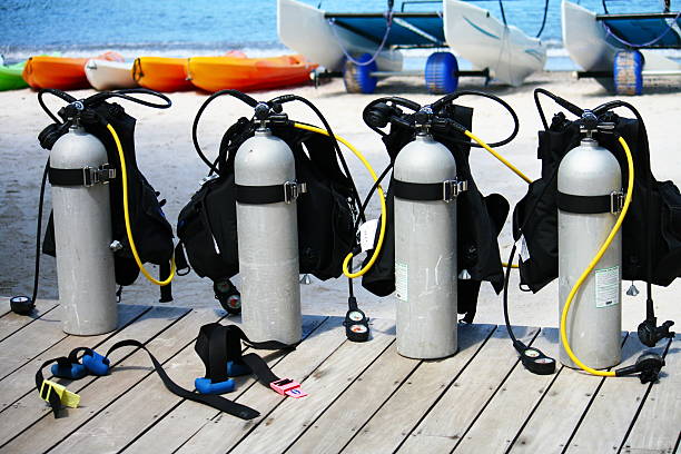 Many oxygen tanks standing in rows as storage  in shed. I took this photo during my vacation on the island Bonaire. Fifty percent of all the tourists here are divers! The diving shop fills the air tanks for diving.
