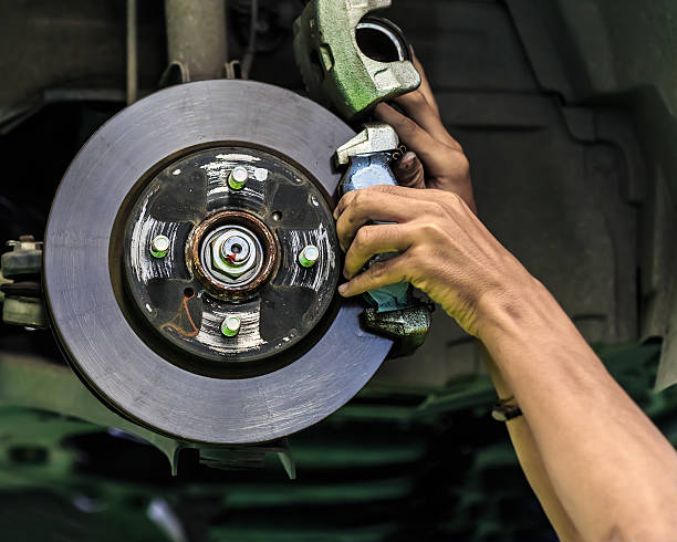 istock Hands of a mechanic install brake lining 184430155