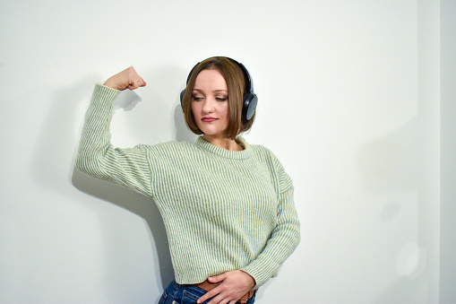 A portrait of a young Caucasian female wearing headphones.