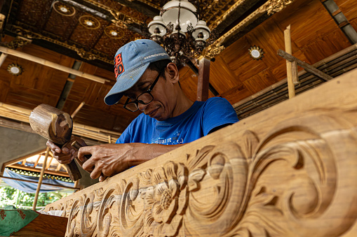 Wood carving craftsmen from Jepara are working on carvings for the construction of the mosque foyer on December 05, 2017  in Demak, Indonesia.