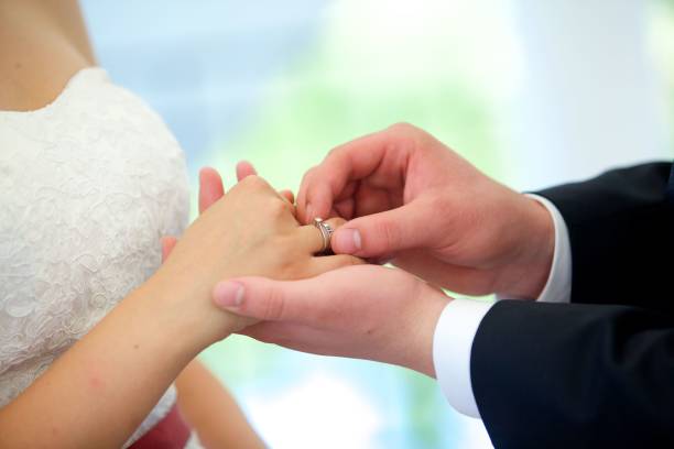 istock The bride and groom put the ring on the wedding ceremony 1844329310