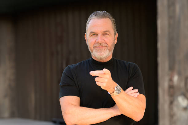 istock Man with a black T-shirt pointing to the camera 1844336177