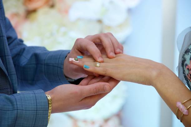 istock The bride and groom put the ring on the wedding ceremony 1844340246
