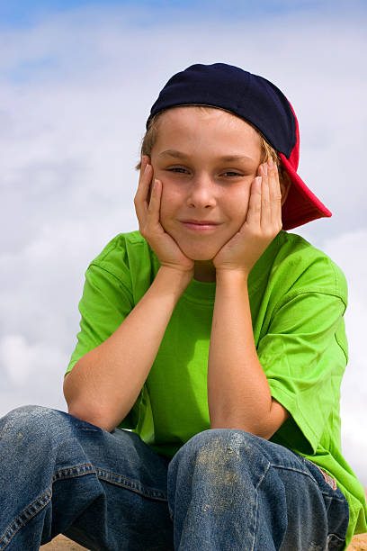 istock Smiling boy relaxing head in hands 184434858