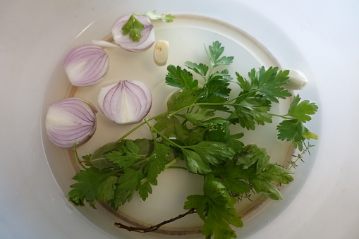 Aromatic plants red onion parsley thyme garlic ingredients for a cooking recipe